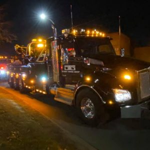 tow truck lit up at night