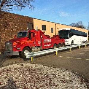 towing truck haulng a tour bus